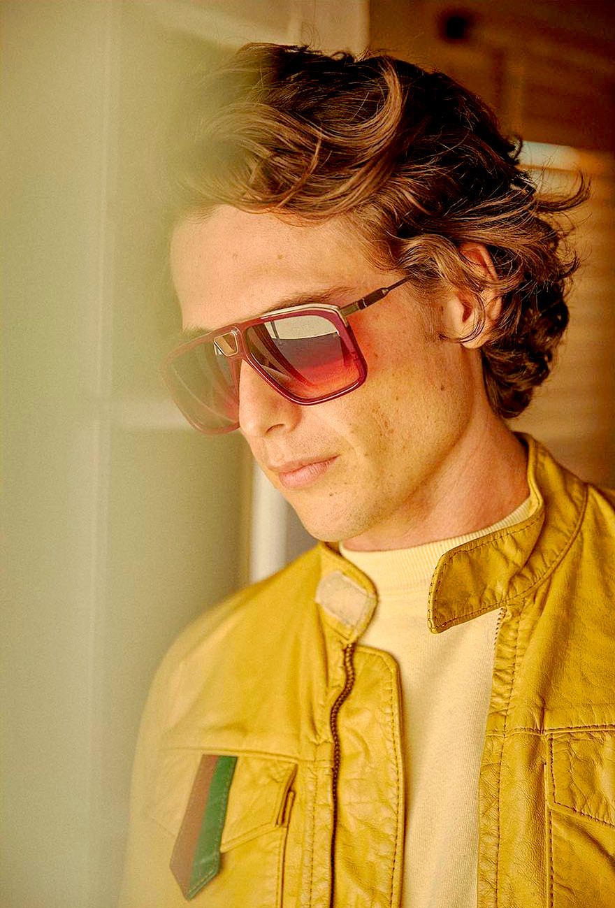 Deadpan portrait of a man in tinted aviators