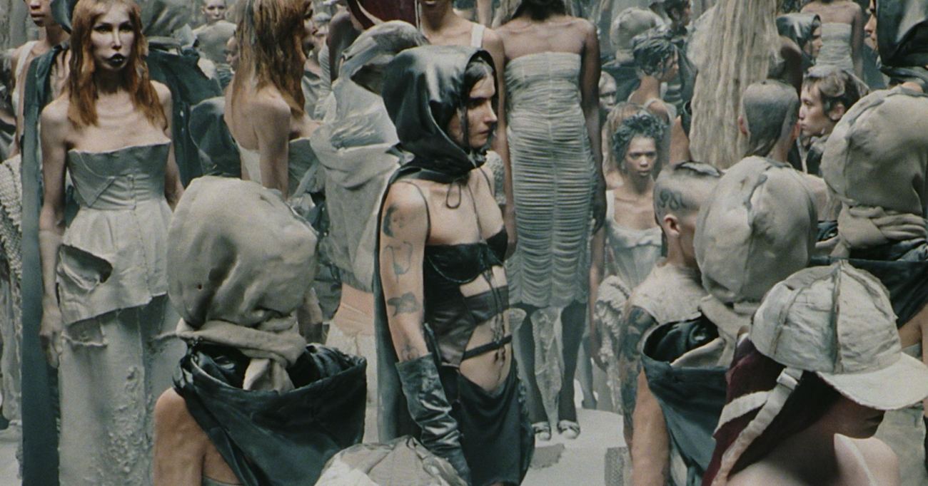 Fashion film still with a crowd of models